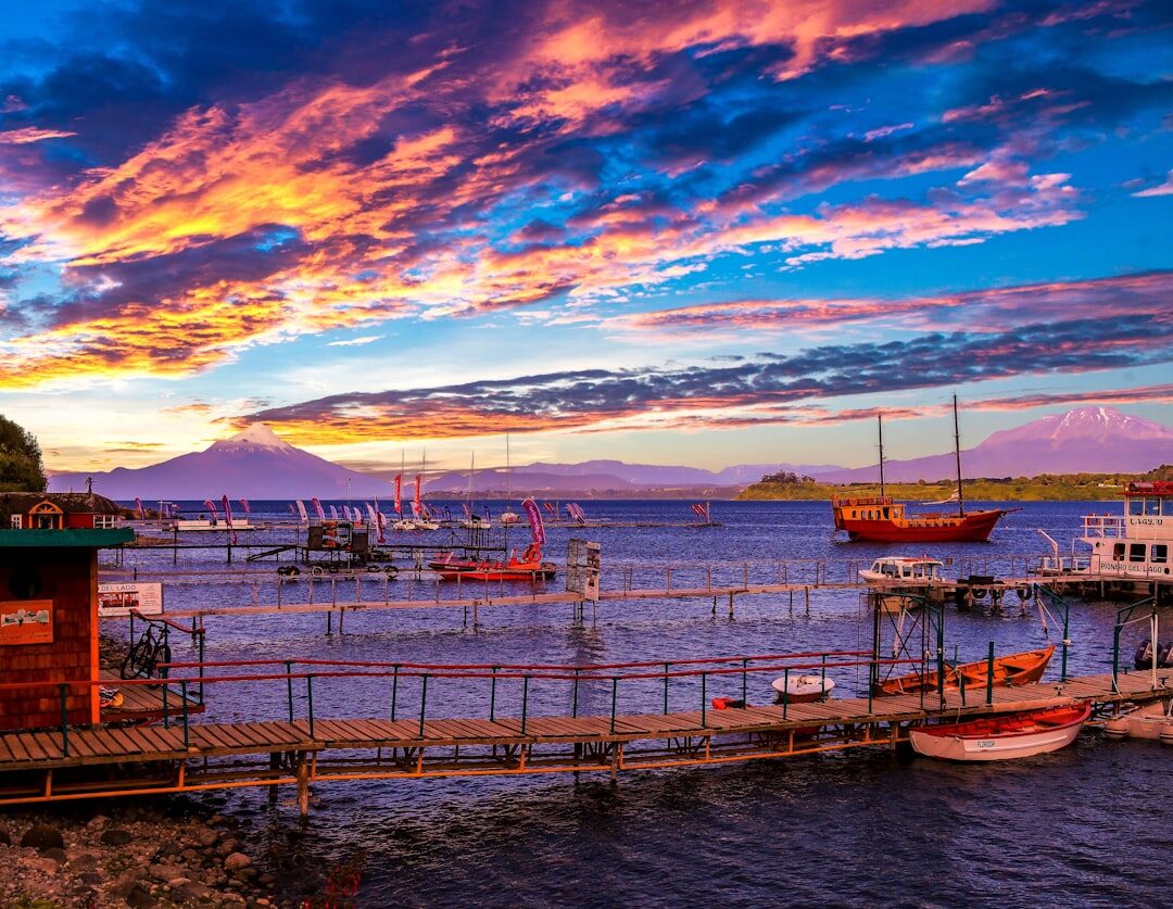 Wooden pier over the water in Puerto Montt with fishing boats