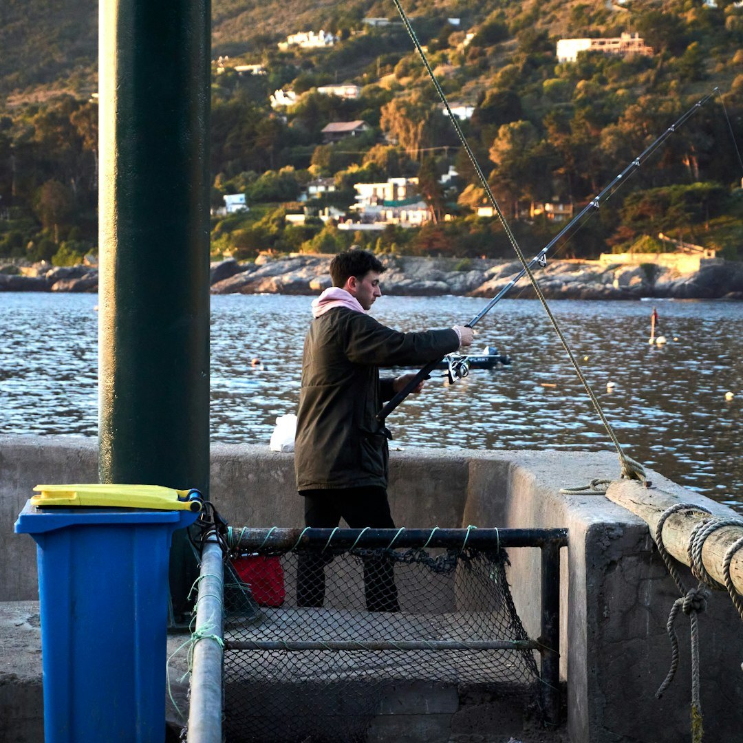 Chilean fisherman mending nets at a small coastal cove